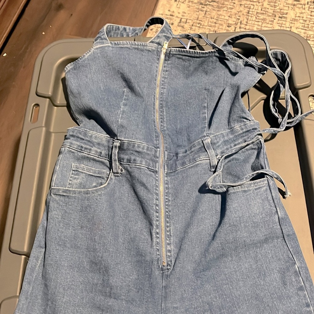 Denim jumpsuit open back tie around neck and zipper front flare out pants